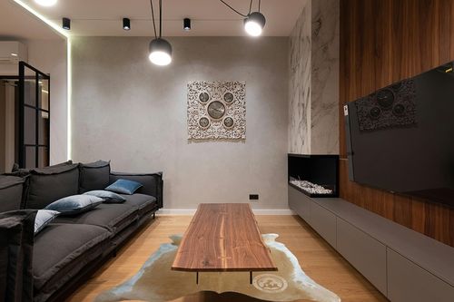 Genuine Palomino Beige and White Cowhide Rug 6 x 7-8 ft. 180 x 240 cm in Dark Wood Living Room with Black Couch