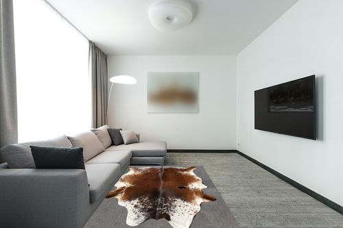 Large Cowhide Rug Tricolor Cowhide Cow Skin Leather Area Rug, Hair On Cow Hide Rugs 5 X 7 ft Black, Brown and White in Modern Living Room with Grey Couch