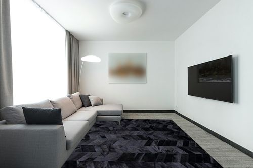New Cowhide Rug Leather. Animal Skin Patchwork Area Carpet (8 X 10) in Modern Living Room with Grey Couch