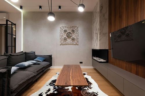 Sunshine Cowhides Genuine Tricolor Cowhide Rug - Luxurious Cow Rug for Bedroom, Living Room, and Home Decor Enthusiasts - Masterpiece of Style and Functionality - XL 6x7-8ft (180x220cm) in Dark Wood Living Room with Black Couch