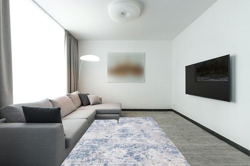 SAFAVIEH Amelia Collection Area Rug - 6' x 9', Grey & Blue, Modern Abstract Design, Non-Shedding & Easy Care, Ideal for High Traffic Areas in Living Room, Bedroom (ALA705F) in Modern Living Room with Grey Couch