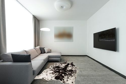 MustMat Faux Cowhide Rug Black and White Cow Print Area Rug Large Animal Hide Carpet Western Decor 5.2ft x 6.6ft in Modern Living Room with Grey Couch