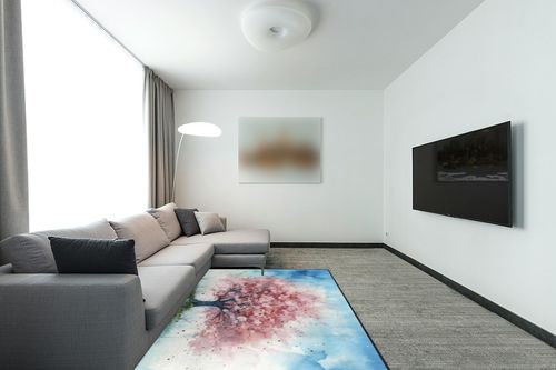 DNOVING Large Non-Slip Area Rug 5x7ft Washable Fluffy Rug, Cherry Blossom Tree Design, Rubber Backing, Pink and White Petals on Blue Sky in Modern Living Room with Grey Couch
