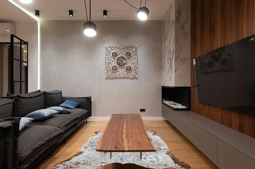 Sunshine Cowhides Genuine Salt and Pepper Brown and White Cowhide Rug - Luxurious Cow Rug for Bedroom, Living Room, and Home Decor - Masterpiece of Style and Functionality - 6x7ft (180x210cm) in Dark Wood Living Room with Black Couch
