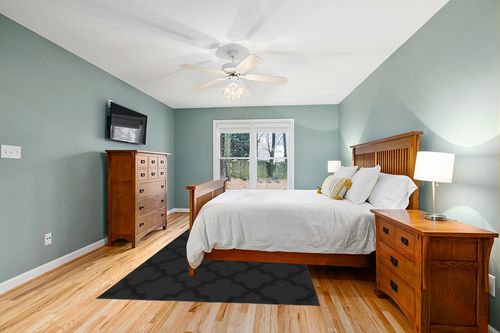 Garland Rug Quatro 6 ft. x 9 ft. Area Rug Black in Teal and Orange Wood Bedroom