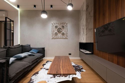 rodeo Genuine Cowhide Rug: Hand-Picked & Authentic Real Cowhide Rug for Western Home Decor - Texas Rug Extra Large - Rustic Rug, Cow Hide Carpet Rugs TR68 Size Approx 6x8 ft (180x240 cm) in Dark Wood Living Room with Black Couch