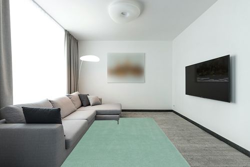 SAFAVIEH Fifth Avenue Collection Area Rug - 6' x 9', Green, Handmade Modern Solid Wool, Ideal for High Traffic Areas in Living Room, Bedroom (FTV128Y) in Modern Living Room with Grey Couch