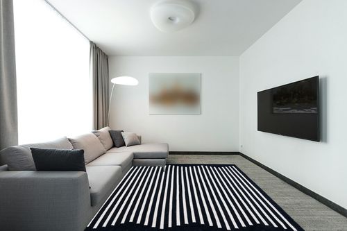 SAFAVIEH Montauk Collection Area Rug - 8' x 10', Black & Ivory, Handmade Flat Weave Boho Farmhouse Cotton Modern Stripe, Ideal for High Traffic Areas in Living Room, Bedroom (MTK313Z) in Modern Living Room with Grey Couch