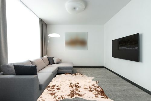 nuLOOM Iraida Contemporary Faux Cowhide Area Rug, 5' 9" x 7' 7", Brown in Modern Living Room with Grey Couch