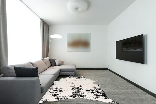 nuLOOM Marcia Machine Washable Faux Cowhide Area Rug, 5' x 6' 7", Black in Modern Living Room with Grey Couch