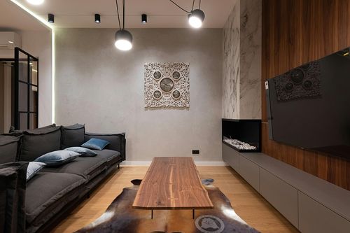 Sunshine Cowhides Genuine Mahogany Brown Cowhide Rug - Luxurious Cow Rug for Bedroom, Living Room, and Home Decor Enthusiasts - Masterpiece of Style and Functionality - XL 6x7-8ft (180x240cm) in Dark Wood Living Room with Black Couch