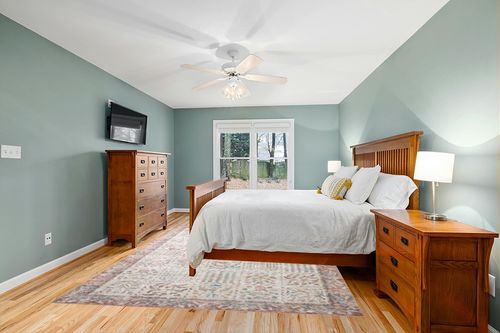 Loloi Rifle Paper Co. x Maison Cream 7'-6" x 9'-6" Area Rug in Teal and Orange Wood Bedroom