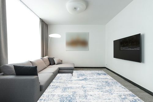 SAFAVIEH Amelia Collection Area Rug - 9' x 12', Ivory & Blue, Modern Abstract Design, Non-Shedding & Easy Care, Ideal for High Traffic Areas in Living Room, Bedroom (ALA700A) in Modern Living Room with Grey Couch