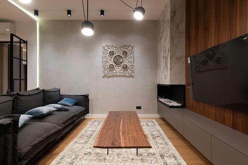 nuLOOM 6' x 9' Splashguard Machine Washable Area Rug with Waterproof Spill Proof Surface, Non Slip Backing and Stain Resistant for Living Room, Bedroom, Kitchen, Dining Room, Davi Taupe in Dark Wood Living Room with Black Couch