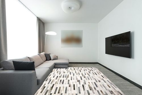 Loloi II Maddox Collection MAD-01 Ivory/Grey 7'-6" x 9'-6" Area Rug in Modern Living Room with Grey Couch