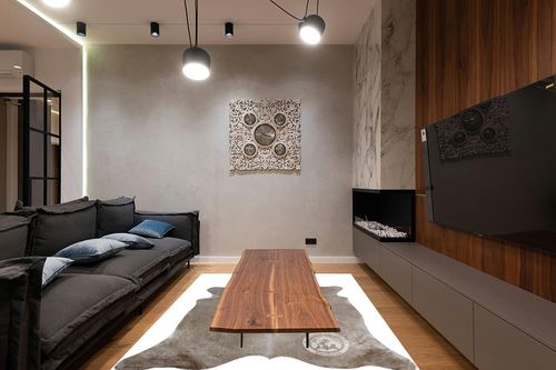 Sunshine Cowhides Genuine Taupe Cowhide Rug - Luxurious Cow Rug for Bedroom, Living Room, and Home Decor Enthusiasts - Masterpiece of Style and Functionality - 6x6-7ft (180x210cm) in Dark Wood Living Room with Black Couch