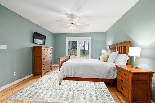 Loloi Rifle Paper Co. x Maison Rosette Ivory 8'-4" x 11'-6" Area Rug in Teal and Orange Wood Bedroom