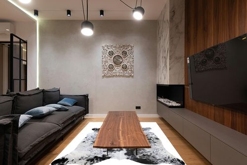 Sunshine Cowhides Genuine Salt and Pepper Black and White Longhorn Cowhide Rug - Luxurious Cow Rug for Bedroom, Living Room, and Home Decor Enthusiasts - Stylish Masterpiece - 6x7ft (180x210cm) in Dark Wood Living Room with Black Couch
