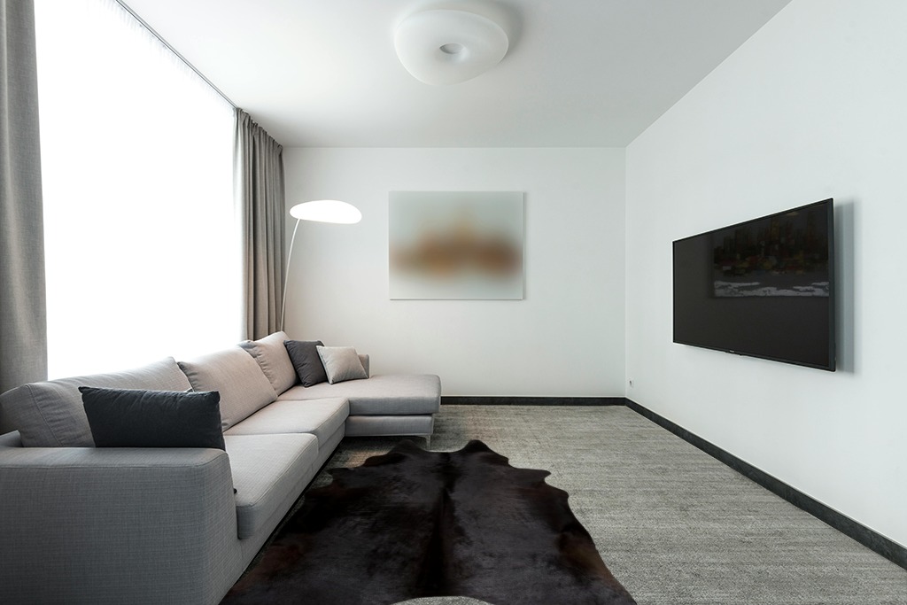 rodeo Solid Black Cowhide Rug (5x7) in Modern Living Room with Grey Couch