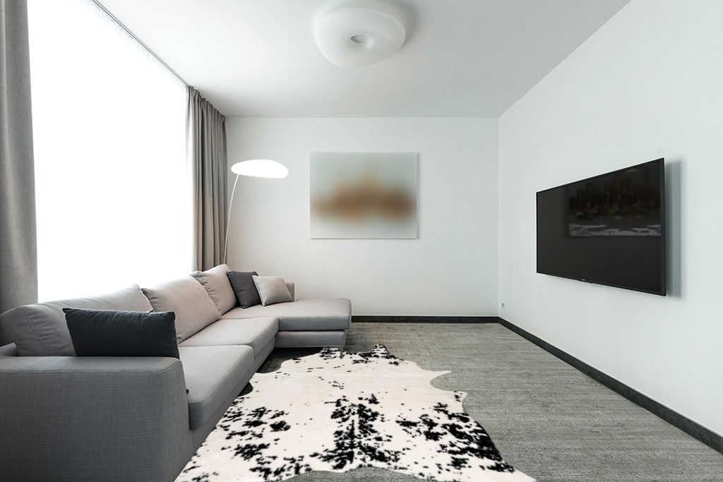 nuLOOM Marcia Machine Washable Faux Cowhide Area Rug, 5' 9" x 7' 7", Black in Modern Living Room with Grey Couch