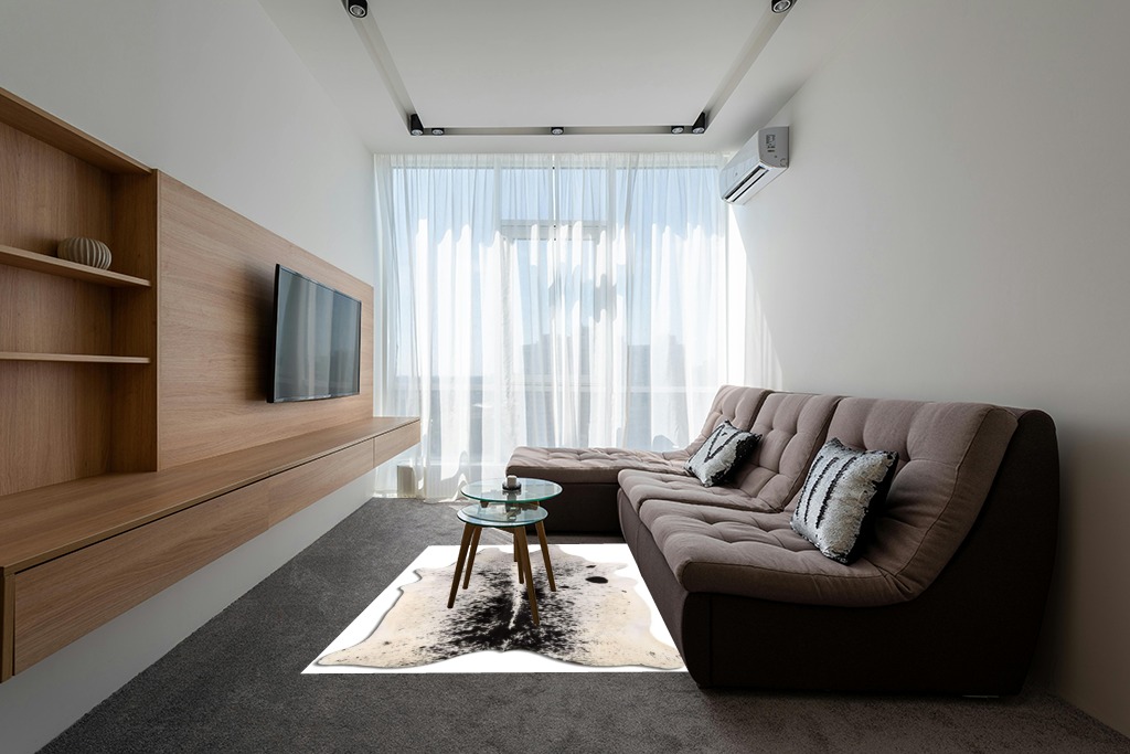 Cowhide Area Rug in Grey Living Room with Brown Couch